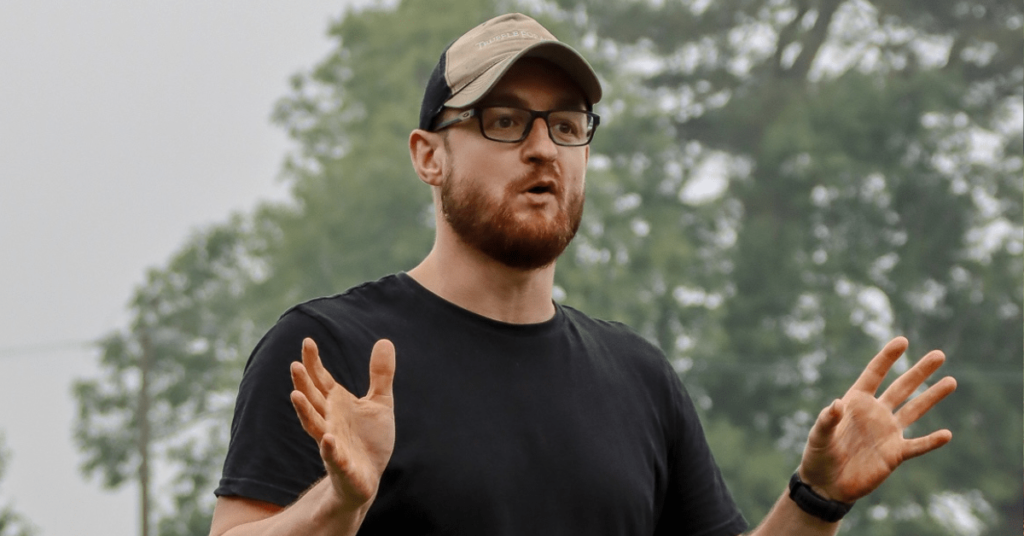 Image of Ben Sweet in black t shirt and hat training a class